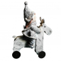 Preview: Winterkind auf rollendem Rentier charmante Weihnachtsfigur im Strickdesign